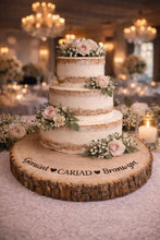 Load image into Gallery viewer, Personalised CARIAD Log Slice Cake Stand, Welsh Wedding Cake Stand, Rustic Wedding Cake Base, Engraved Names, Engagement Dessert Board
