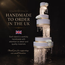 Load image into Gallery viewer, Infographic showing what is included with a crystal chandelier wedding cake stand: buy as a 3 tier set or buy sizes individually, LED lights, crystal chandelier strands, silver or gold connectors, and strong clear acrylic support. Image shows a tall 3 tier white and gold cake stand with hanging crystal strands, white flowers, and a clear acrylic base.
